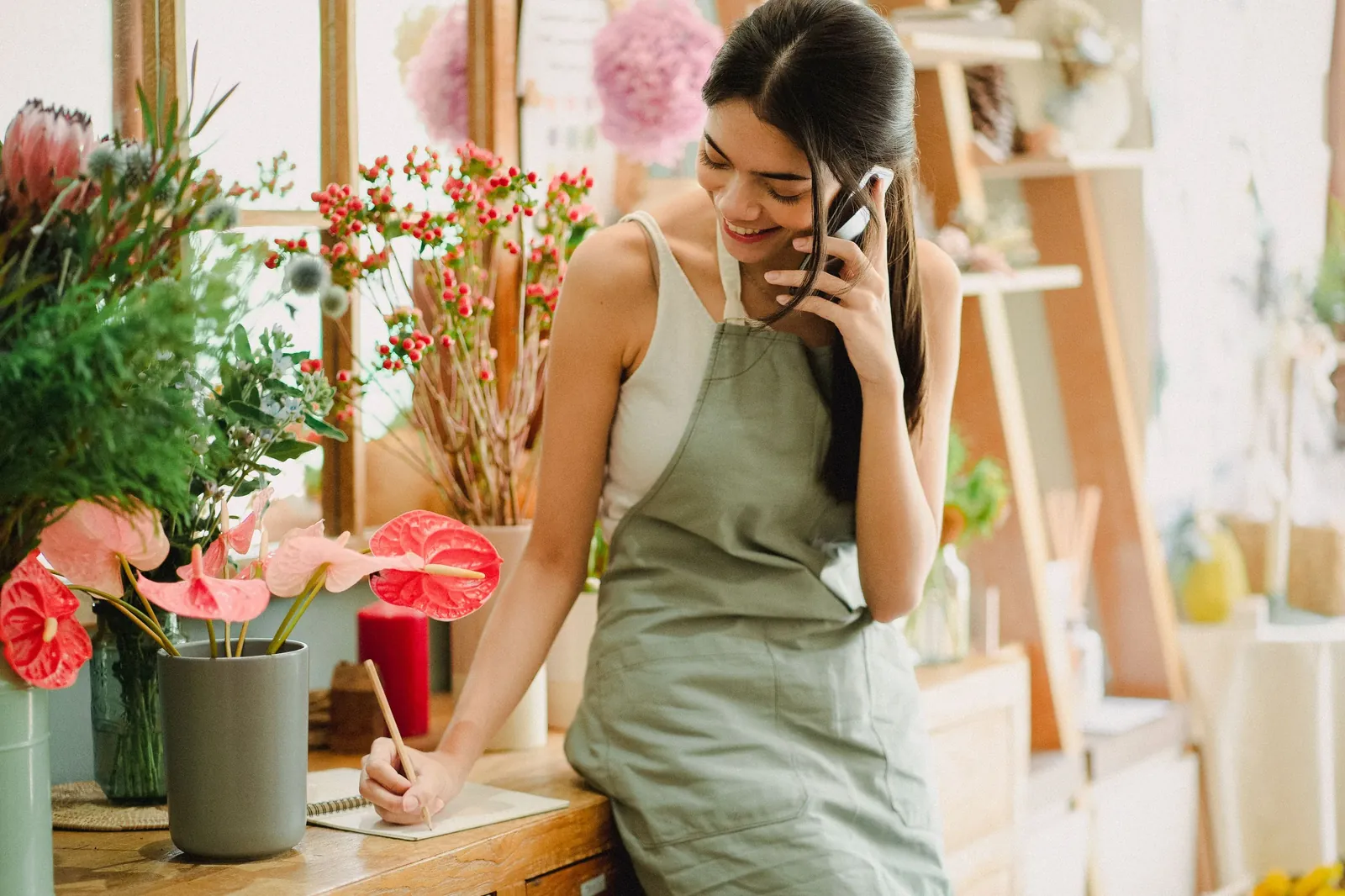 Business owner sending automatic SMS to her customers