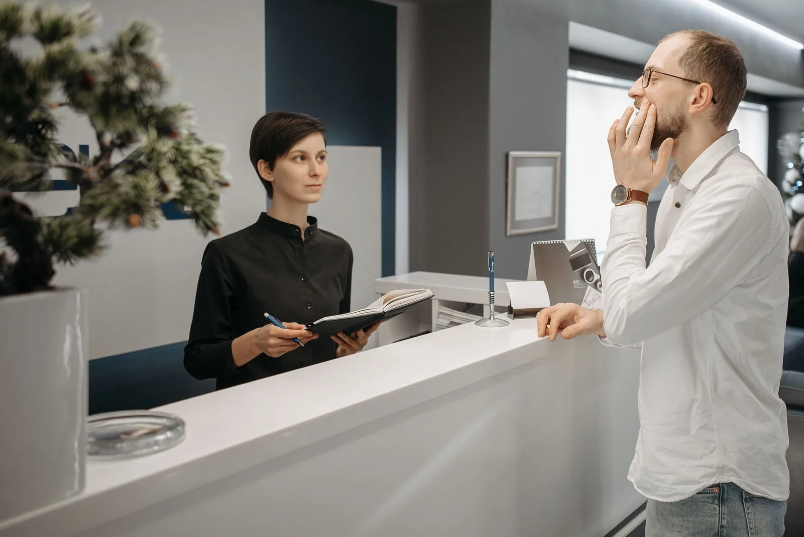 Person using a scheduling app on a tablet