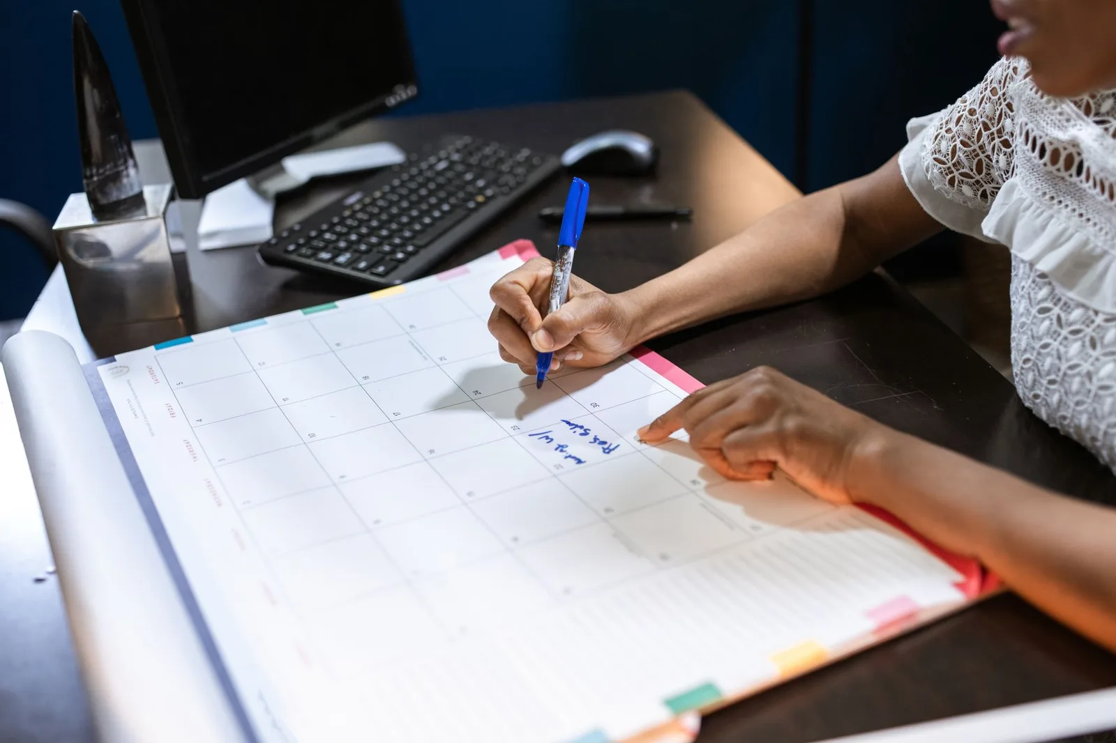 A professional using an online appointment calendar on a laptop