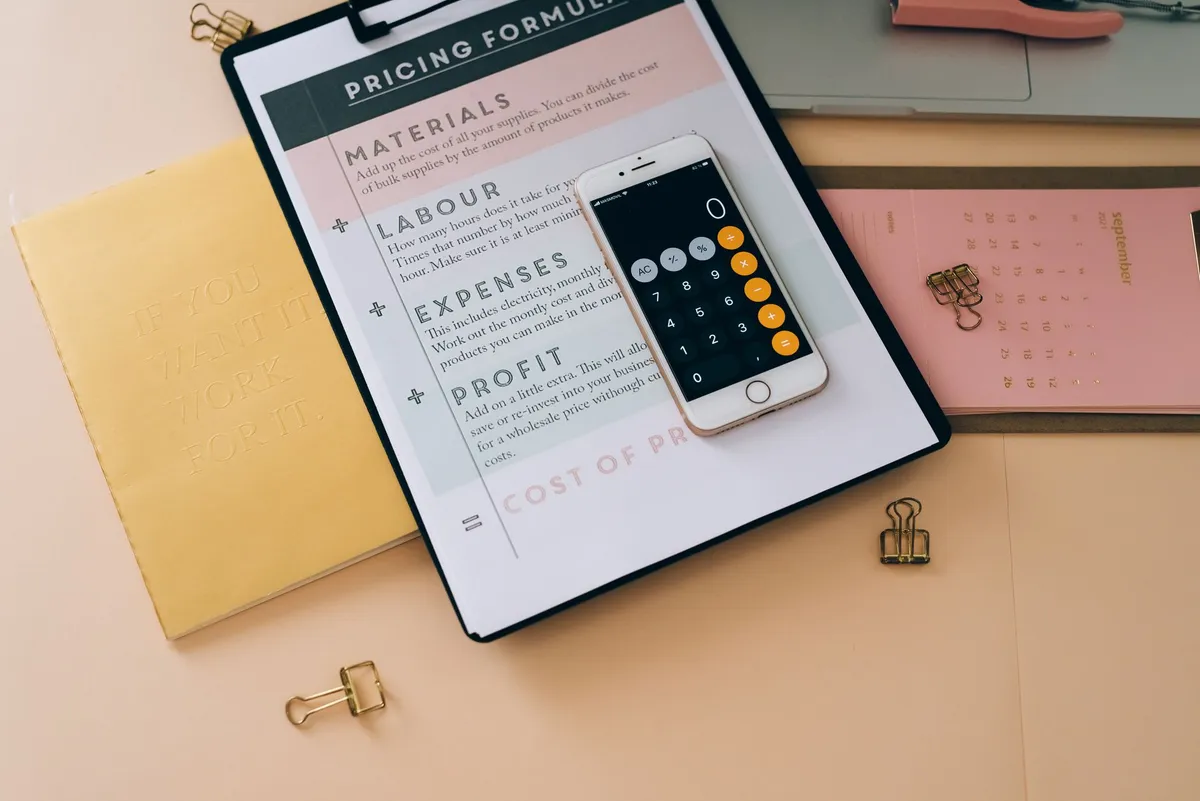Smartphone and cost documents on a business desk