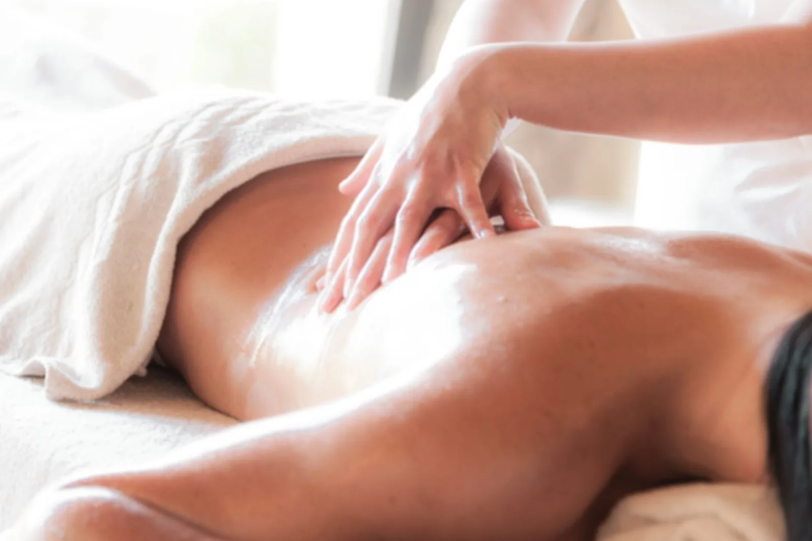 A cozy massage therapy room with ambient lighting