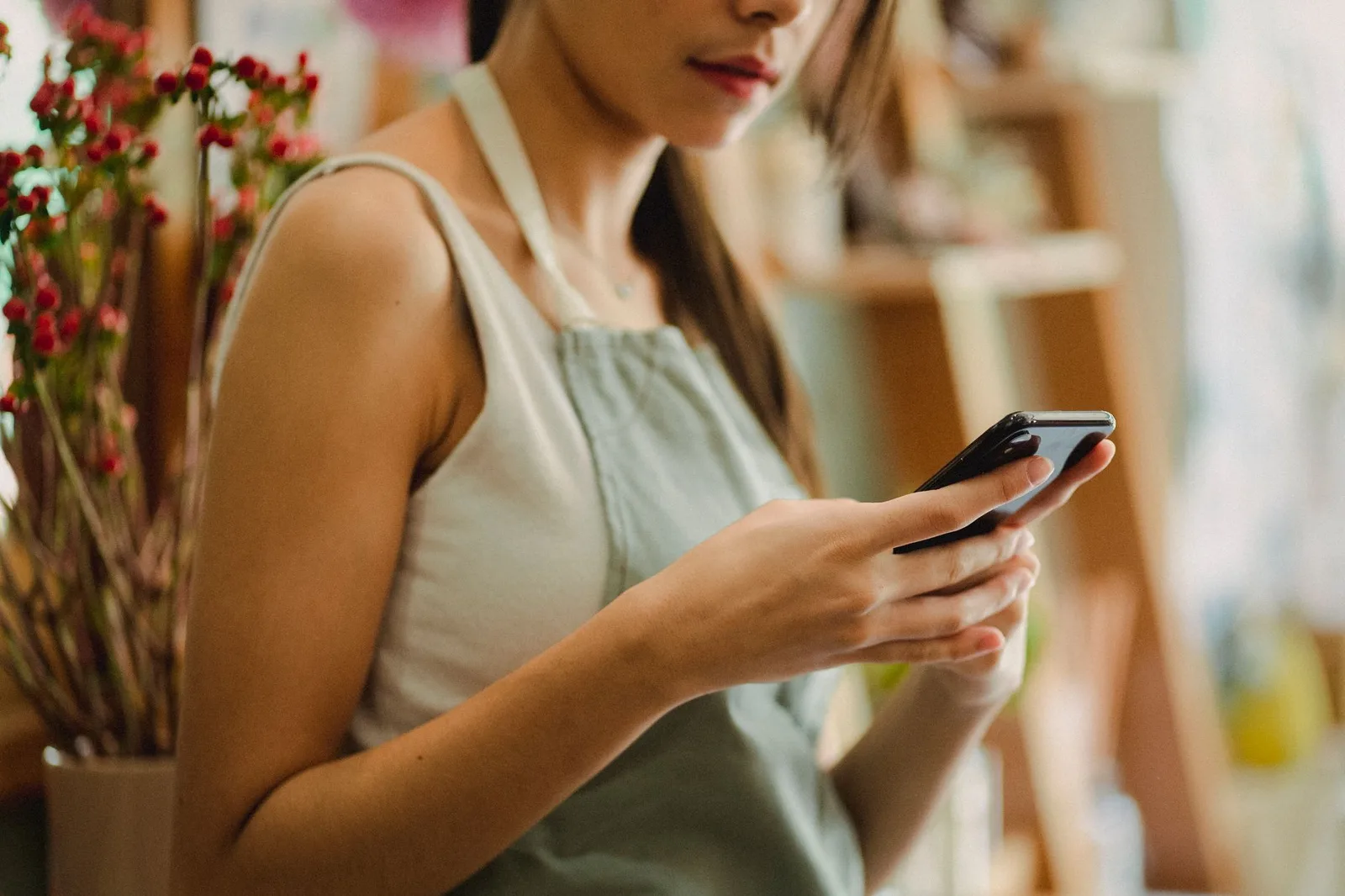 Business owner checking SMS reminders on phone