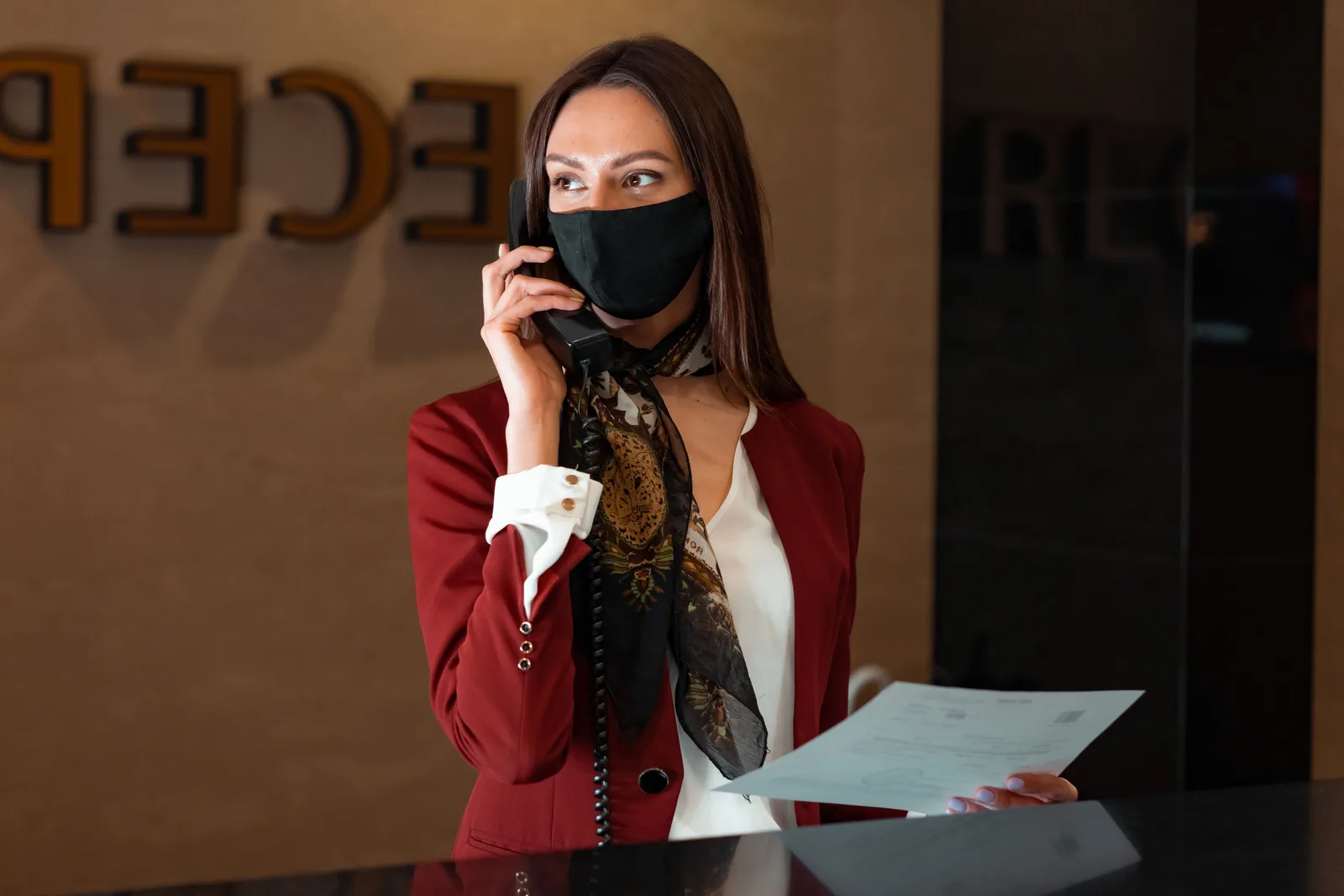 Front-desk staff answering a phone call for an appointment