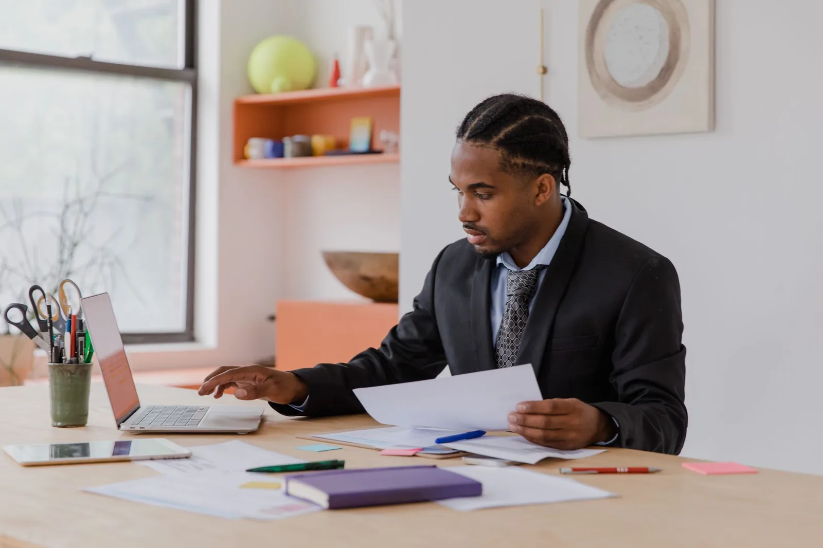 A business owner managing online bookings on a laptop