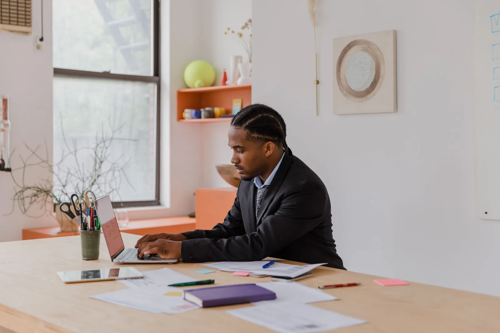 A business owner managing online bookings on a laptop