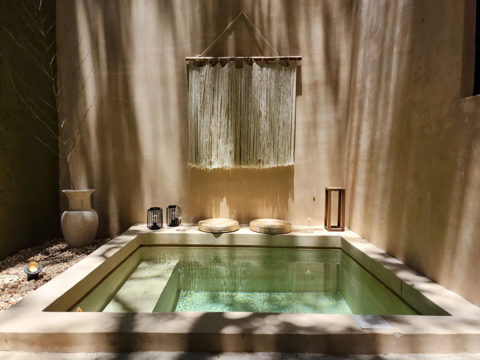 A serene spa interior with candles and a massage table